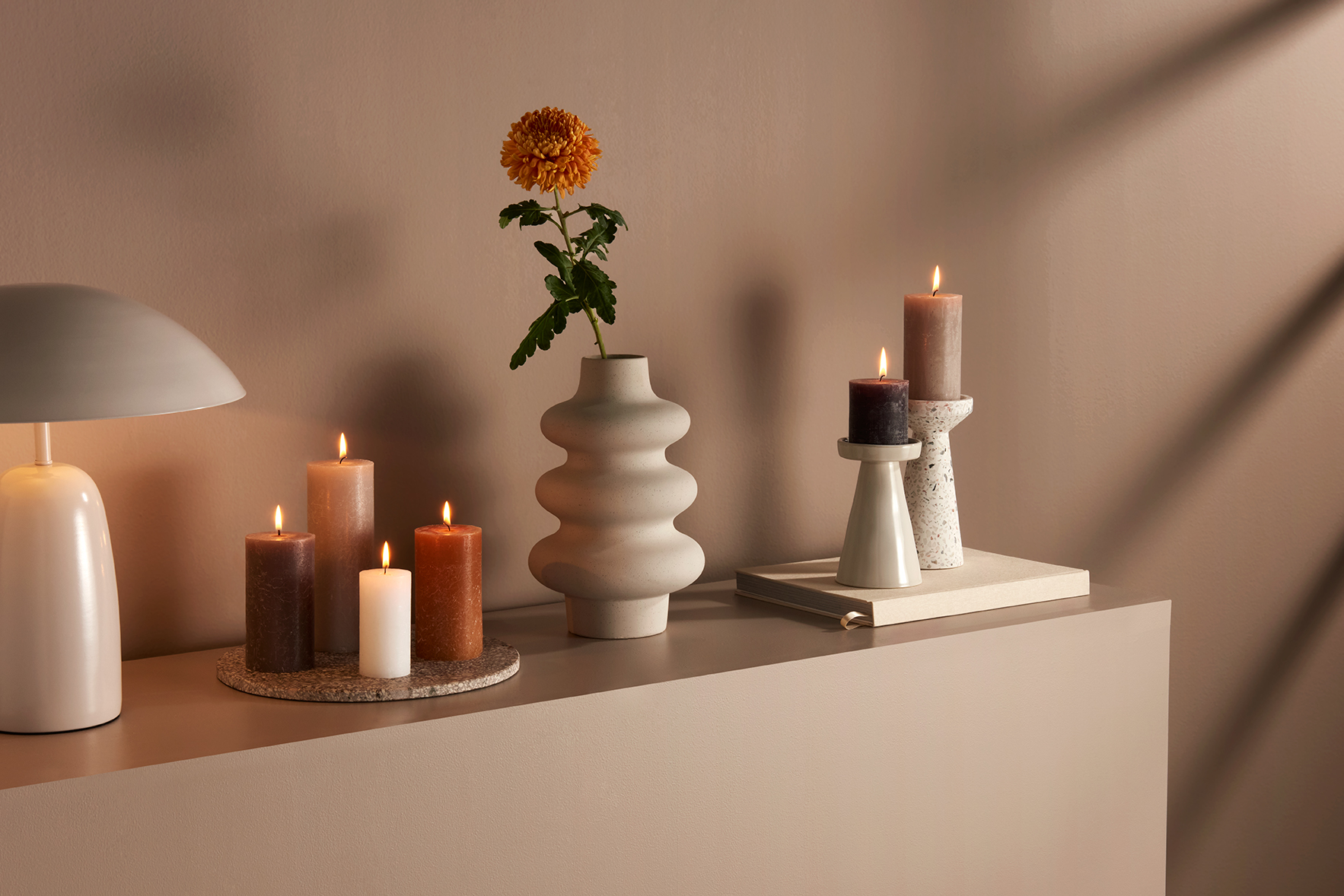 Product photography for Bolsius - neutral candles and vase on beige background with refined styling